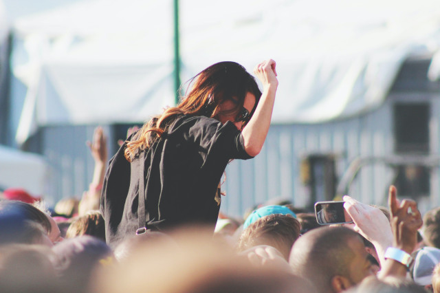girl dancing on shoulders at festival